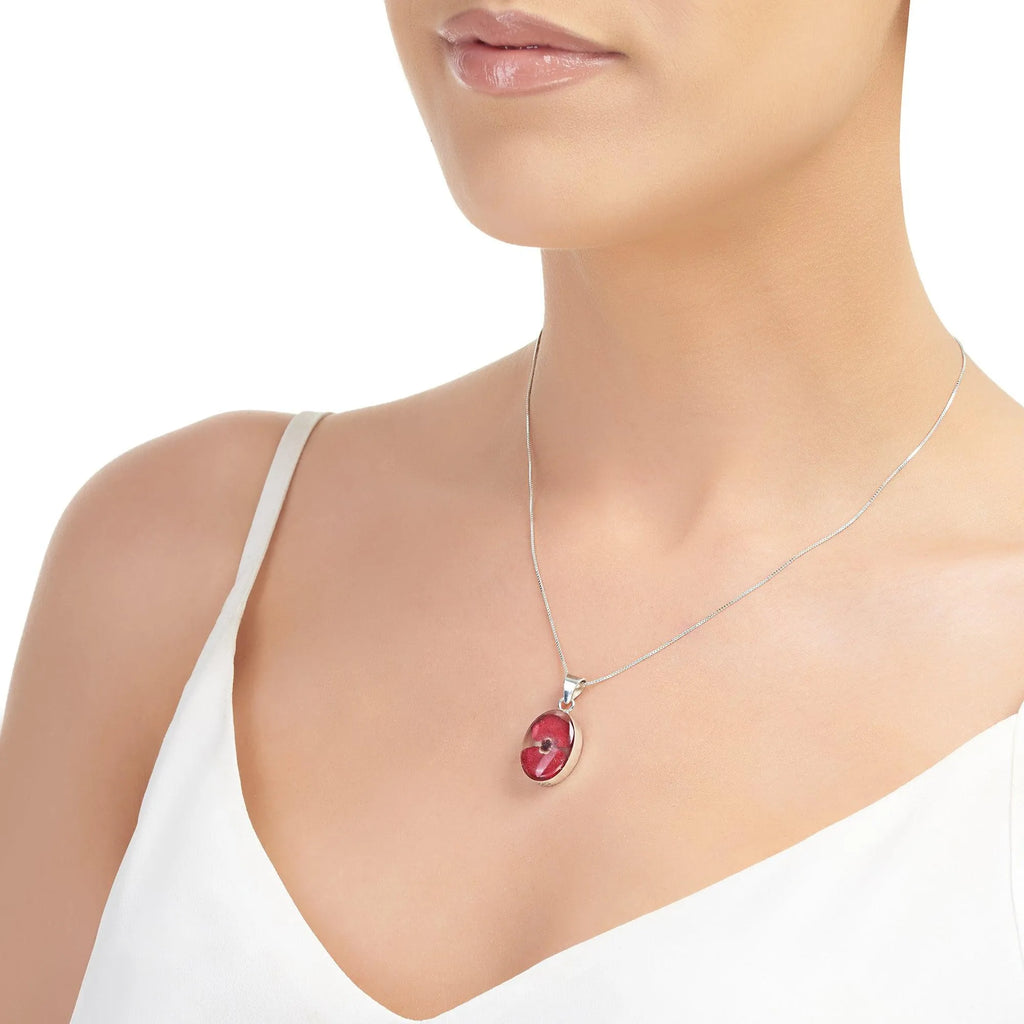 Poppy necklace by Shrieking Violet® Sterling silver oval pendant handmade with a single mini poppy (Euphorbia milii).