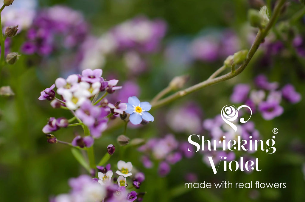 Sterling silver bracelet. Heart shapes filled with tiny purple flowers.